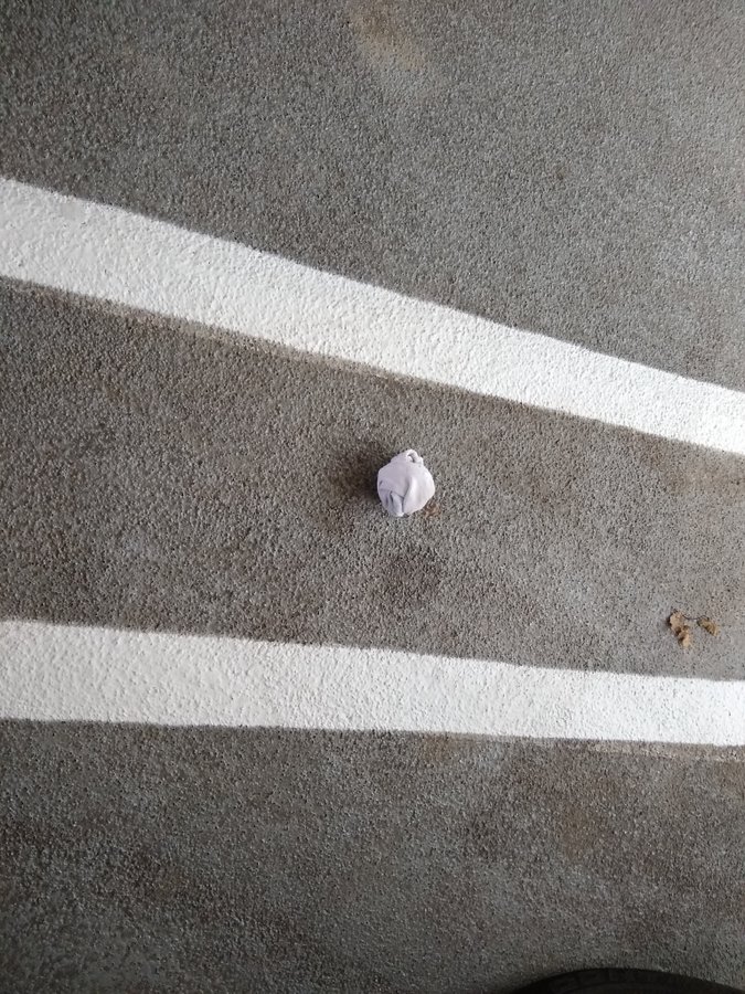 wadded up white sock on pavement